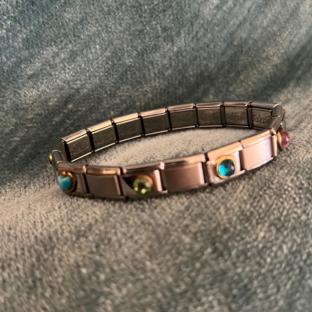 Vintage Talexia silver tone charm bracelet with six charms.